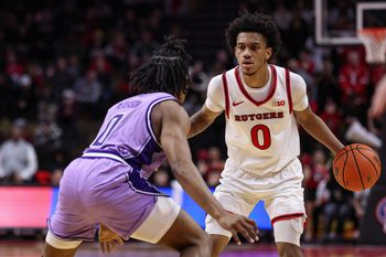 Feb 24, 2026; Piscataway, New Jersey, USA; Rutgers Scarlet Knights guard Tariq Francis (0) is guarded by Washington Huskies guard Quimari Peterson (0) during the second half at Jersey Mike's Arena. Mandatory Credit: Vincent Carchietta-Imagn Images