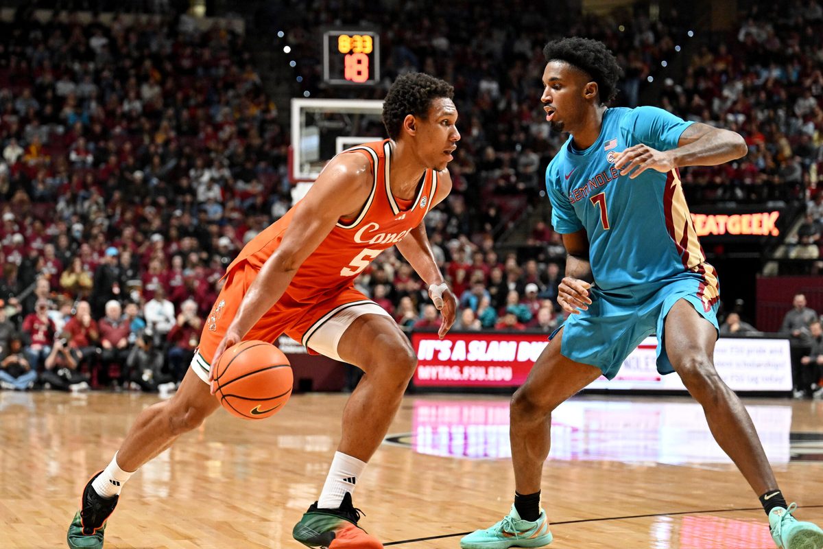 Feb 24, 2026; Tallahassee, Florida, USA; Miami Hurricanes forward Malik Reneau (5) drives to the net past Florida State Seminoles forward Chauncey Wiggins (7) during the first half at Donald L. Tucker Center. Mandatory Credit: Melina Myers-Imagn Images