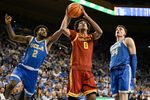 Feb 24, 2026; Los Angeles, California, USA; Southern California Trojans guard Alijah Arenas (0) drives to the basket past UCLA Bruins guard Donovan Dent (2) and forward Tyler Bilodeau (34) during the first half at Pauley Pavilion presented by Wescom Financial. Mandatory Credit: Robert Hanashiro-Imagn Images