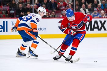Feb 26, 2026; Montreal, Quebec, CAN; New York Islanders defenseman Matthew Schaefer (48) defends the puck against Montreal Canadiens right wing Cole Caufield (13) during overtime at Bell Centre. Mandatory Credit: David Kirouac-Imagn Images