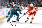 Feb 26, 2026; San Jose, California, USA; San Jose Sharks defenseman Sam Dickinson (6) and Calgary Flames center Nazem Kadri (91) fight for the puck during the first period at SAP Center at San Jose. Mandatory Credit: Bob Kupbens-Imagn Images