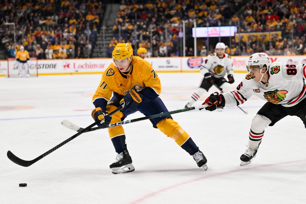 Feb 26, 2026; Nashville, Tennessee, USA; Nashville Predators right wing Matthew Wood (71) and Chicago Blackhawks center Teuvo Teravainen (86) battle for the puck during the third period at Bridgestone Arena. Mandatory Credit: Steve Roberts-Imagn Images