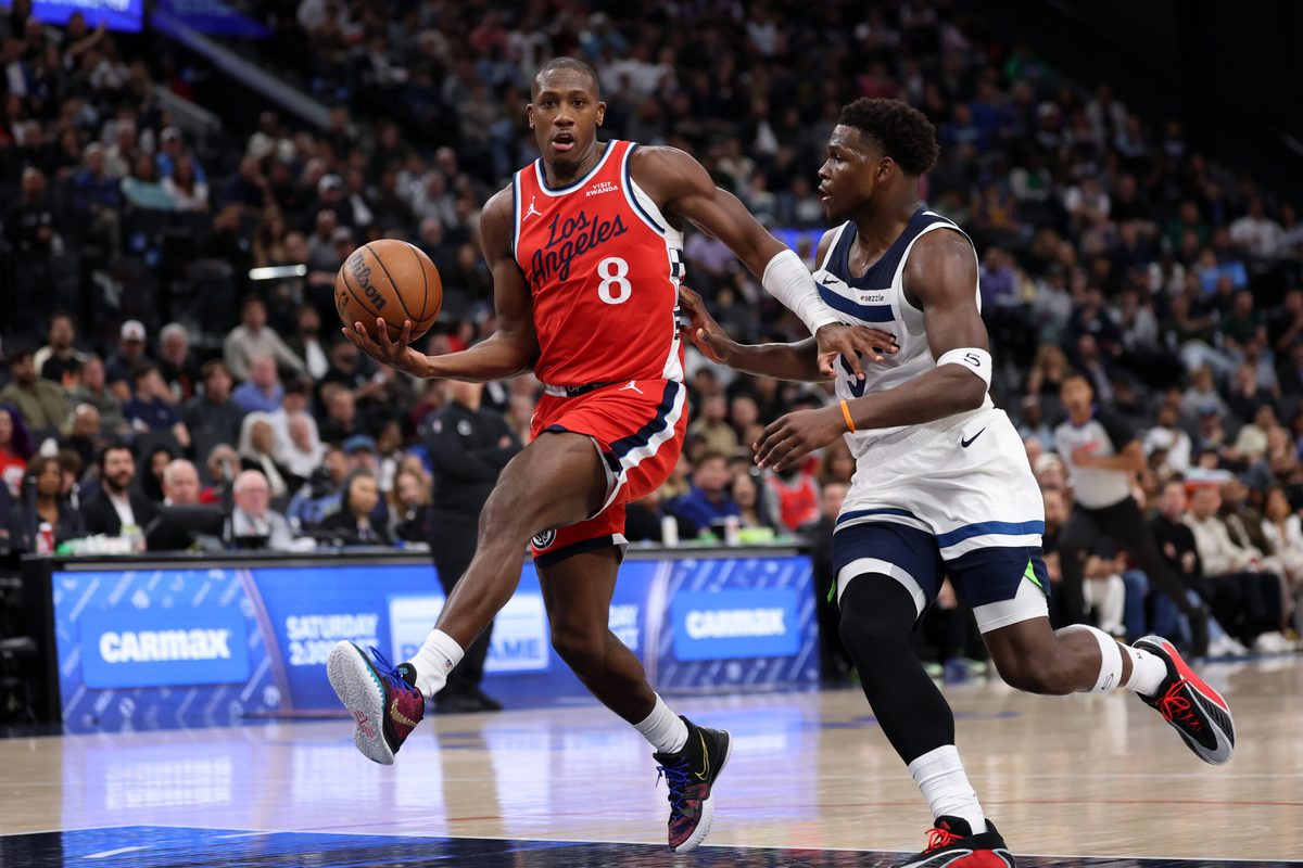 Feb 26, 2026; Inglewood, California, USA; Los Angeles Clippers guard Kris Dunn (8) dribbles the ball against Minnesota Timberwolves guard Anthony Edwards (5) during the second half at Intuit Dome. Mandatory Credit: Kiyoshi Mio-Imagn Images
