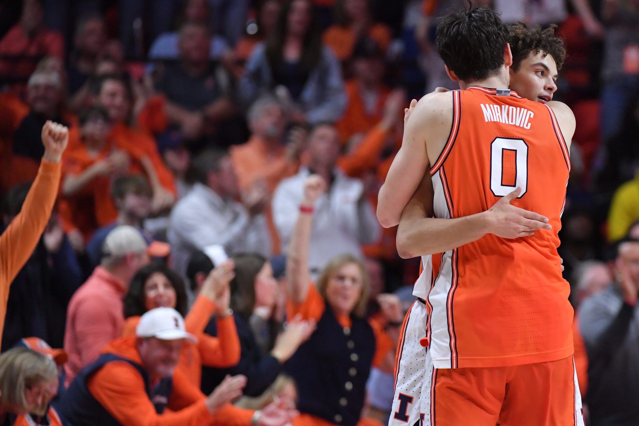 Feb 27, 2026; Champaign, Illinois, USA;  Illinois Fighting Illini forward David Mirkovic (0) embraces Illinois Fighting Illini guard Keaton Wagler (23) after a score during the second half against the Michigan Wolverines at State Farm Center. Mandatory Credit: Ron Johnson-Imagn Images