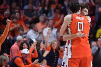 Feb 27, 2026; Champaign, Illinois, USA;  Illinois Fighting Illini forward David Mirkovic (0) embraces Illinois Fighting Illini guard Keaton Wagler (23) after a score during the second half against the Michigan Wolverines at State Farm Center. Mandatory Credit: Ron Johnson-Imagn Images