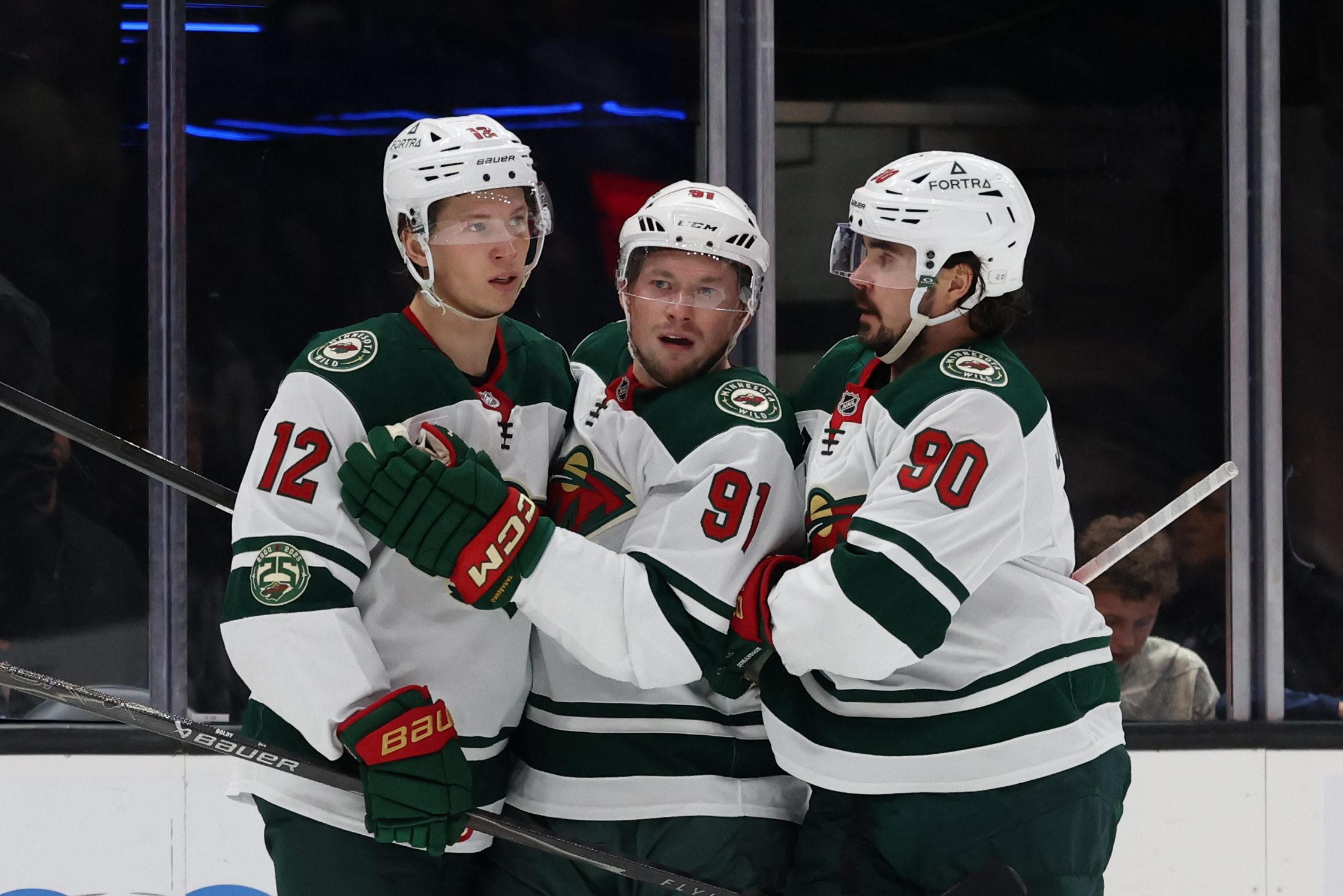 Feb 27, 2026; Salt Lake City, Utah, USA; Minnesota Wild left wing Matt Boldy (12) celebrates scoring a goal with right wing Vladimir Tarasenko (91) and left wing Marcus Johansson (90) during the third period at Delta Center. Mandatory Credit: Rob Gray-Imagn Images