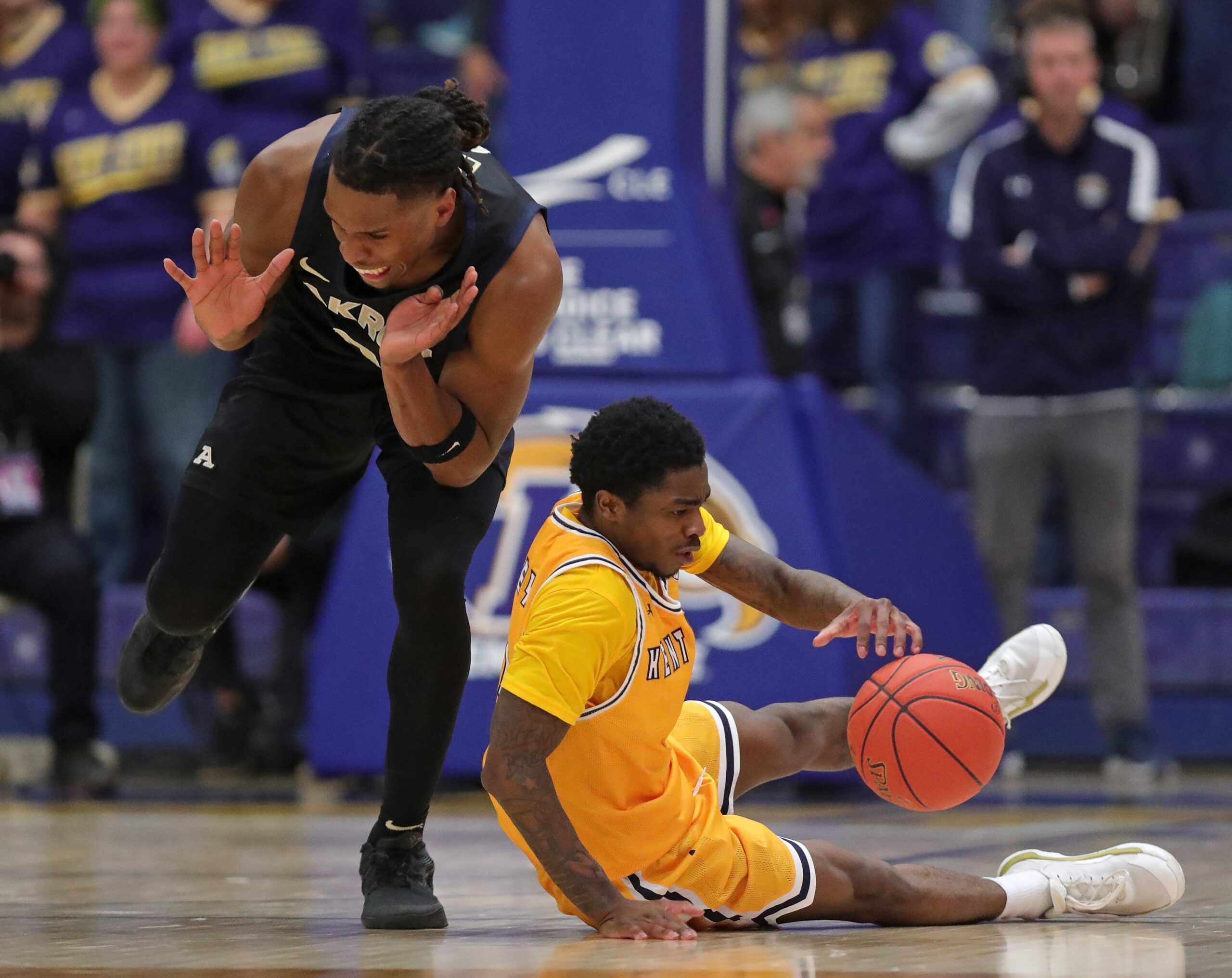 Akron Zips forward Amani Lyles (0) and Kent State Golden Flashes guard Cian Medley (1) fight for a loose ball during the second half of an NCAA college basketball game at the M.A.C. Center, Feb. 27, 2026, in Kent, Ohio.
