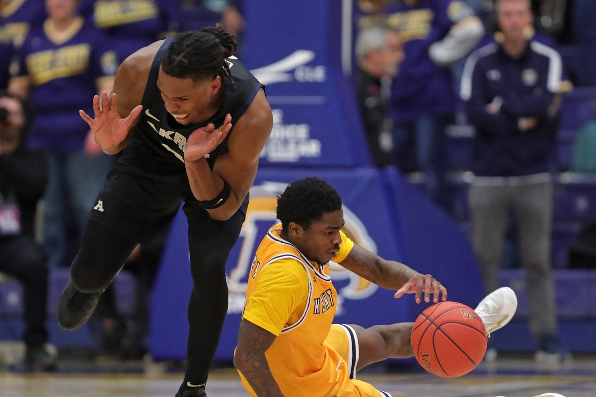 Akron Zips forward Amani Lyles (0) and Kent State Golden Flashes guard Cian Medley (1) fight for a loose ball during the second half of an NCAA college basketball game at the M.A.C. Center, Feb. 27, 2026, in Kent, Ohio.