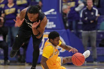 Akron Zips forward Amani Lyles (0) and Kent State Golden Flashes guard Cian Medley (1) fight for a loose ball during the second half of an NCAA college basketball game at the M.A.C. Center, Feb. 27, 2026, in Kent, Ohio.