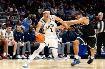 Xavier Musketeers guard Malik Messina-Moore (1) drives on Georgetown Hoyas forward Isaiah Abraham (7) in the second half of the NCAA basketball game at the Cintas Center in Cincinnati.