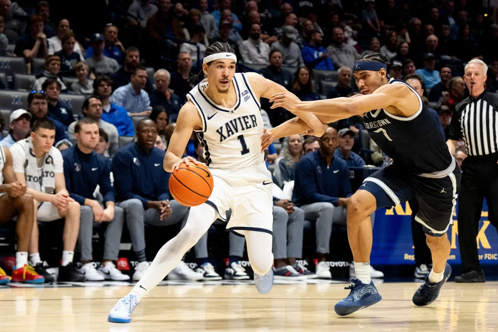 Xavier Musketeers guard Malik Messina-Moore (1) drives on Georgetown Hoyas forward Isaiah Abraham (7) in the second half of the NCAA basketball game at the Cintas Center in Cincinnati.