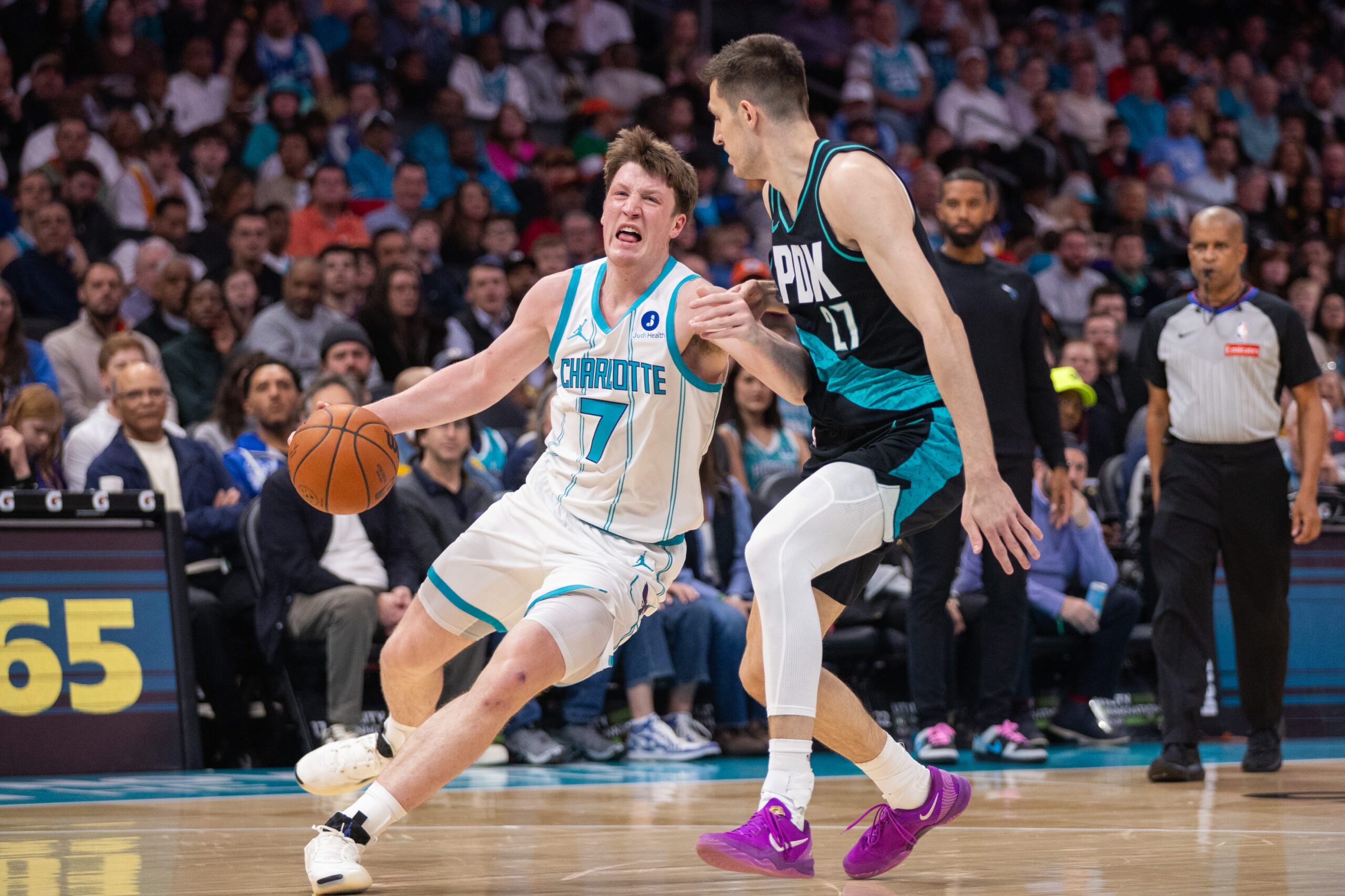 Feb 28, 2026; Charlotte, North Carolina, USA; Charlotte Hornets guard Kon Knueppel (7) drives into Portland Trail Blazers guard Vit Krejci (27) during the first quarter at Spectrum Center. Mandatory Credit: Scott Kinser-Imagn Images
