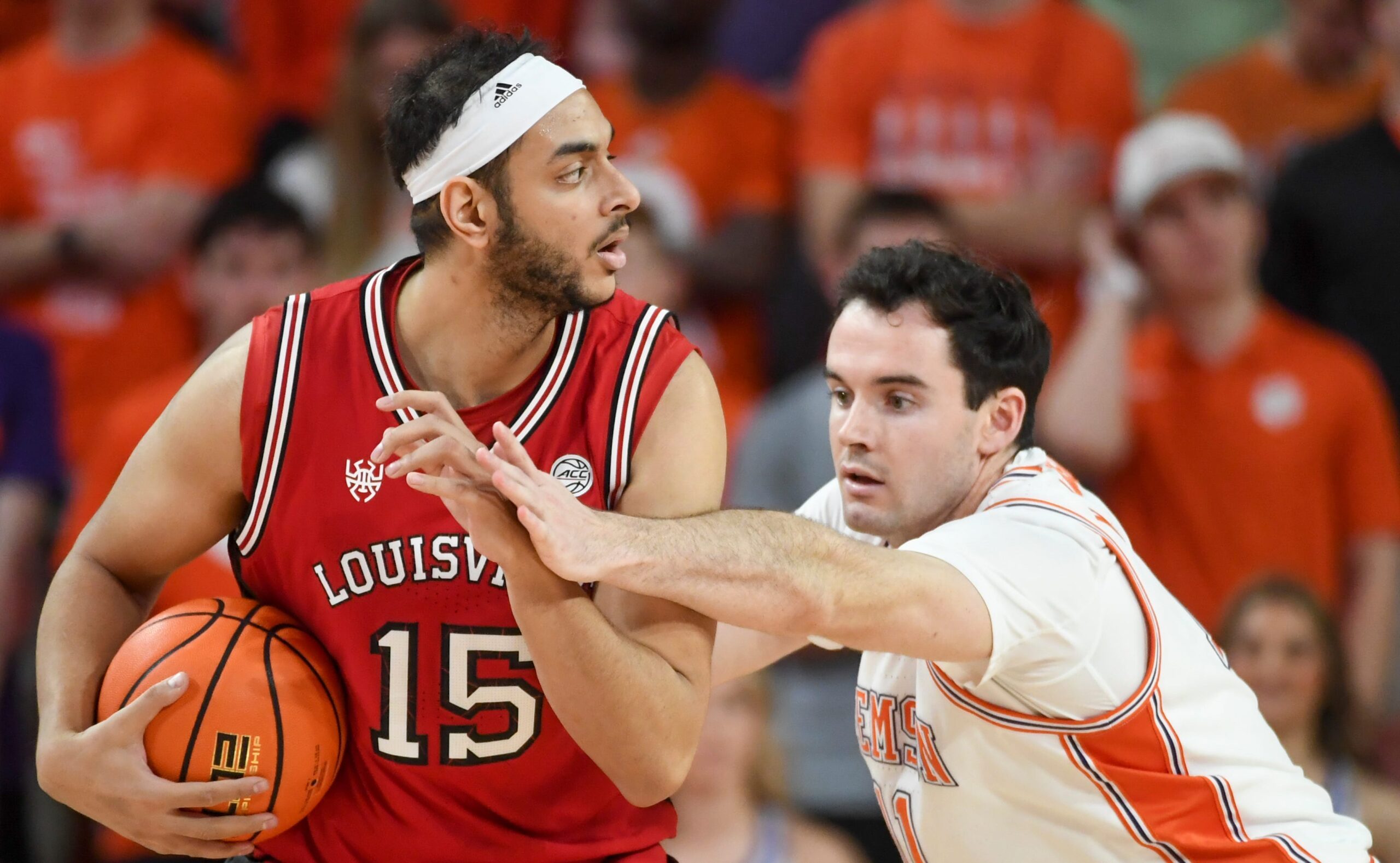 Louisville Cardinals center Aly Khalifa (15) is defended by Clemson Tigers forward Nick Davidson (11) Saturday, Feb. 28, 2026, during the NCAA men’s basketball game at Littlejohn Coliseum in Clemson, South Carolina. Clemson Tigers won 80-75.
