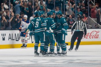 Feb 28, 2026; San Jose, California, USA; San Jose Sharks center Macklin Celebrini (71) celebrates with San Jose Sharks defenseman Dmitry Orlov (9) and teammates after scoring a goal against the Edmonton Oilers during the first period at SAP Center at San Jose. Mandatory Credit: Neville E. Guard-Imagn Images