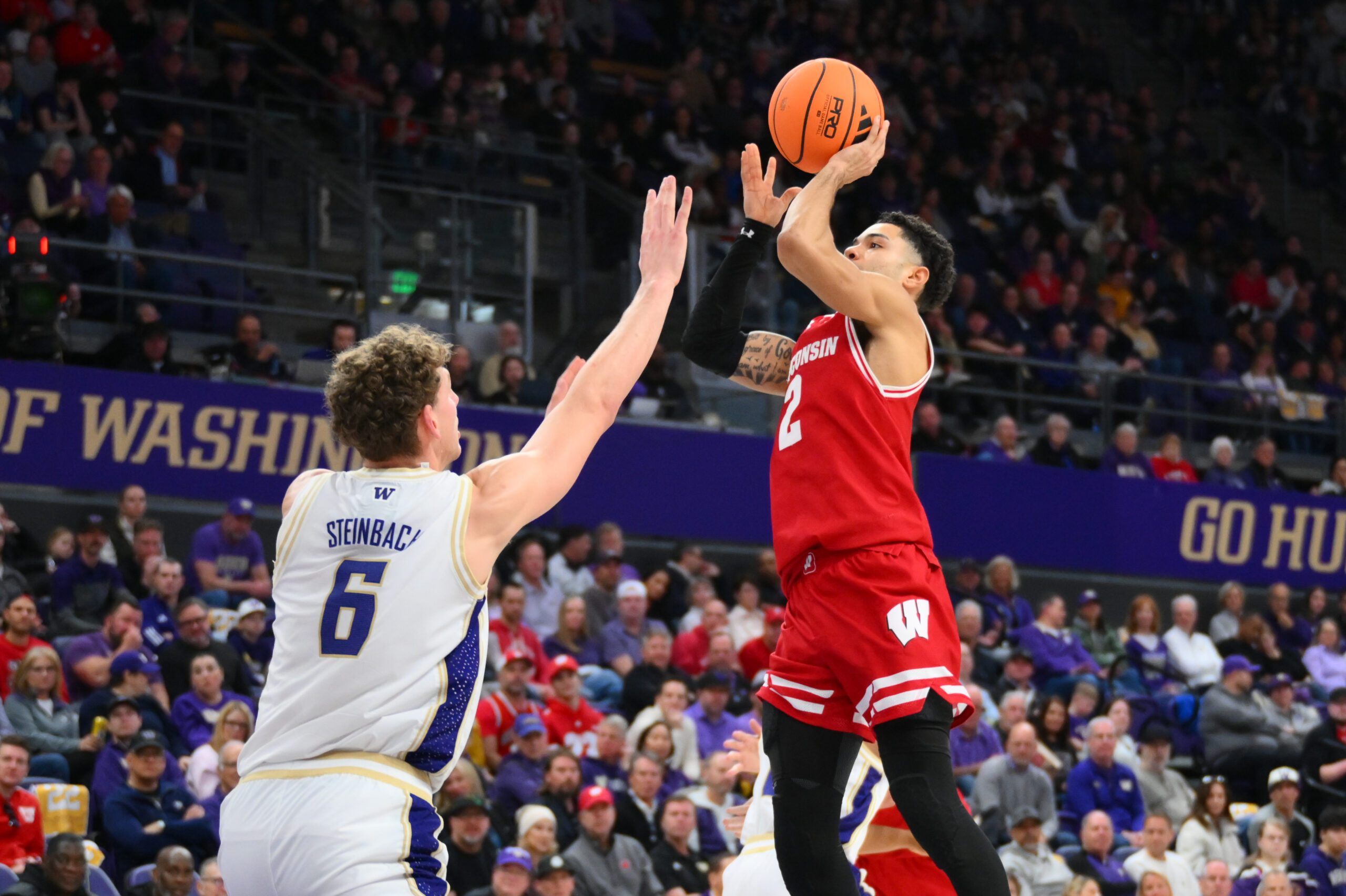 Feb 28, 2026; Seattle, Washington, USA; Wisconsin Badgers guard Nick Boyd (2) shoots the ball over Washington Huskies forward Hannes Steinbach (6) during the second half at Alaska Airlines Arena at Hec Edmundson Pavilion. Mandatory Credit: Steven Bisig-Imagn Images