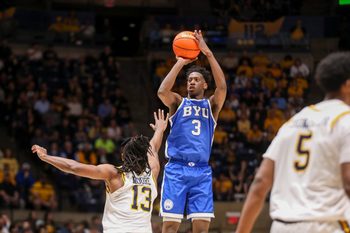 Feb 28, 2026; Morgantown, West Virginia, USA; BYU Cougars forward AJ Dybantsa (3) shoots a three point shot over West Virginia Mountaineers guard Chance Moore (13) during the first half at Hope Coliseum. Mandatory Credit: Ben Queen-Imagn Images