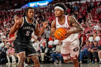 Feb 28, 2026; Athens, Georgia, USA; Georgia Bulldogs guard Marcus Millender (4) passes the ball in front of South Carolina Gamecocks guard Meechie Johnson (5) during the first half at Stegeman Coliseum. Mandatory Credit: Dale Zanine-Imagn Images