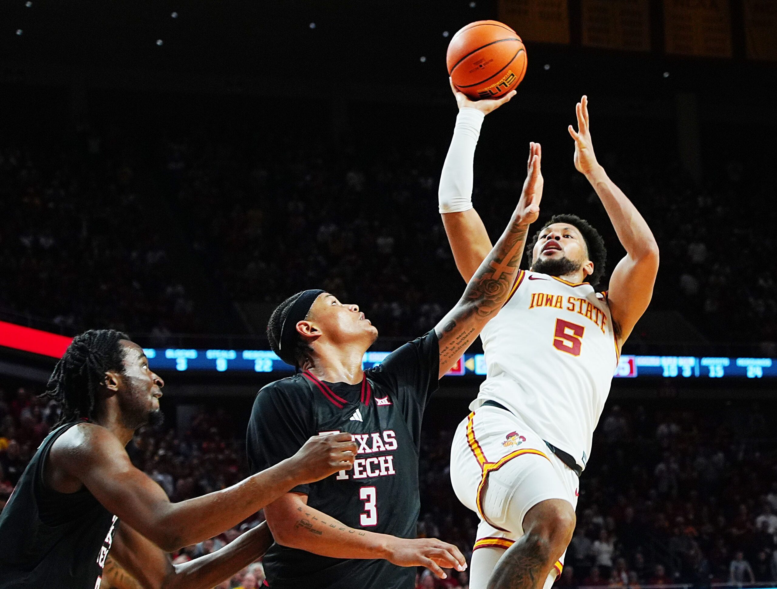 Iowa State Cyclones forward Joshua Jefferson (5) shoots the ball over around Texas Tech Red Raiders forward LeJuan Watts (3) and Texas Tech Red Raiders forward Luke Bamgboye (9) during the second half in the Big-12 conference men’s basketball showdown on Feb. 28, 2026, at Hilton Coliseum in Ames, Iowa.