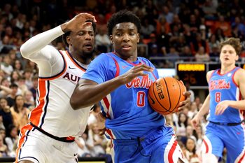 Feb 28, 2026; Auburn, Alabama, USA;  Mississippi Rebels forward Malik Dia (0) gets tangled up with Auburn Tigers guard Kevin Overton (1) during the first half at Neville Arena. Mandatory Credit: John Reed-Imagn Images