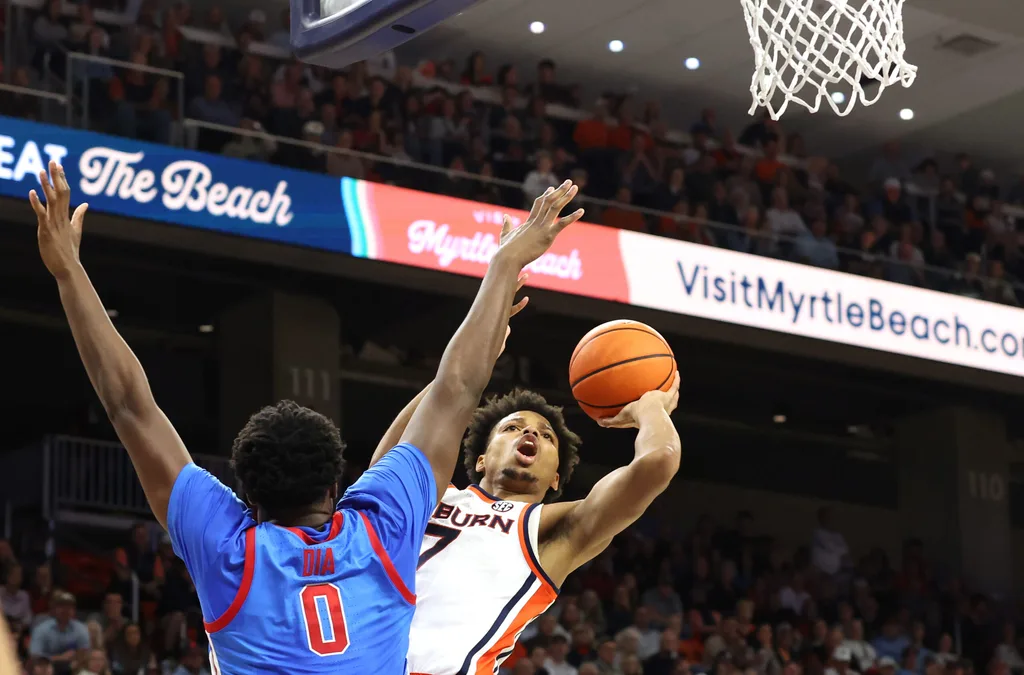 Feb 28, 2026; Auburn, Alabama, USA; Auburn Tigers guard Keyshawn Hall (7) takes a shot against Mississippi Rebels forward Malik Dia (0) during the second half at Neville Arena. Mandatory Credit: John Reed-Imagn Images