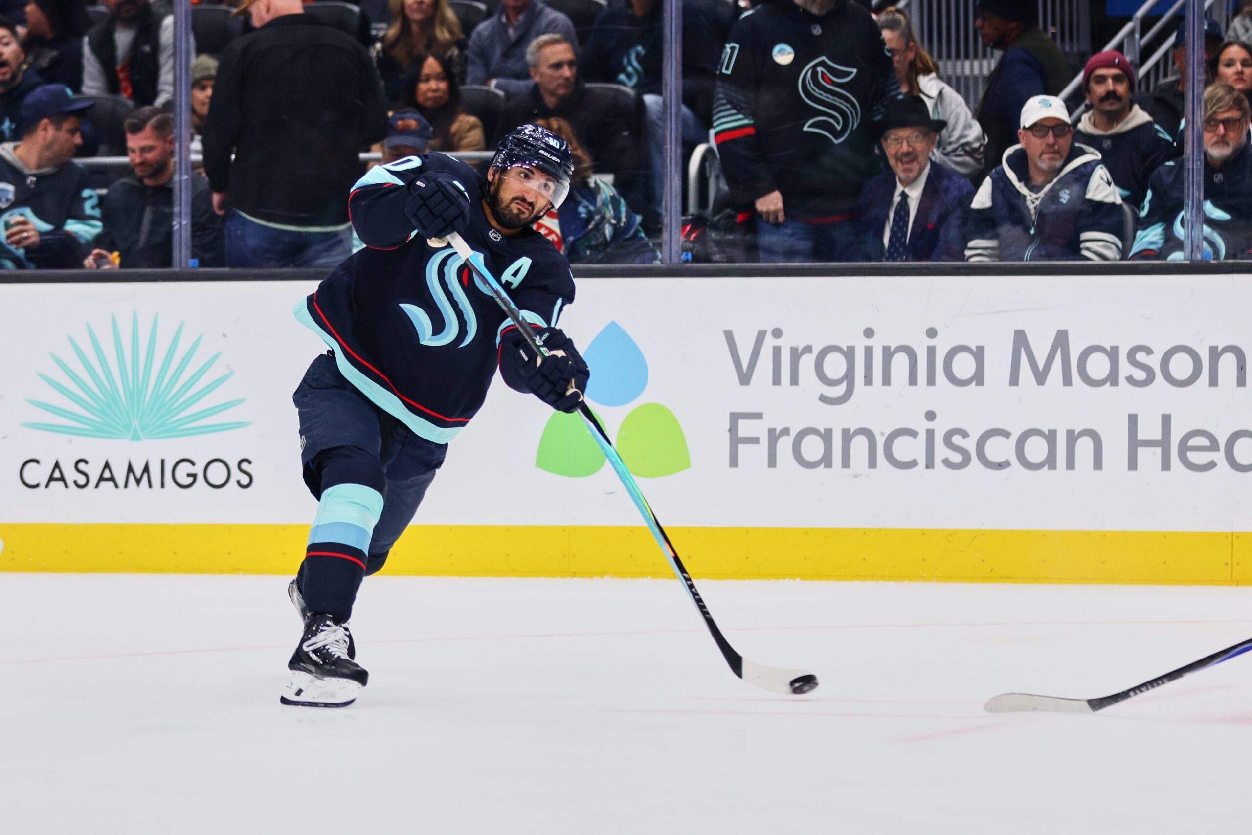 Feb 28, 2026; Seattle, Washington, USA; Seattle Kraken center Matty Beniers (10) takes a shot on goal during the second period against the Vancouver Canucks at Climate Pledge Arena. Mandatory Credit: Blake Dahlin-Imagn Images