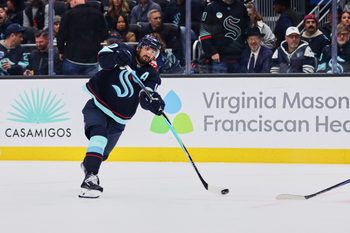 Feb 28, 2026; Seattle, Washington, USA; Seattle Kraken center Matty Beniers (10) takes a shot on goal during the second period against the Vancouver Canucks at Climate Pledge Arena. Mandatory Credit: Blake Dahlin-Imagn Images