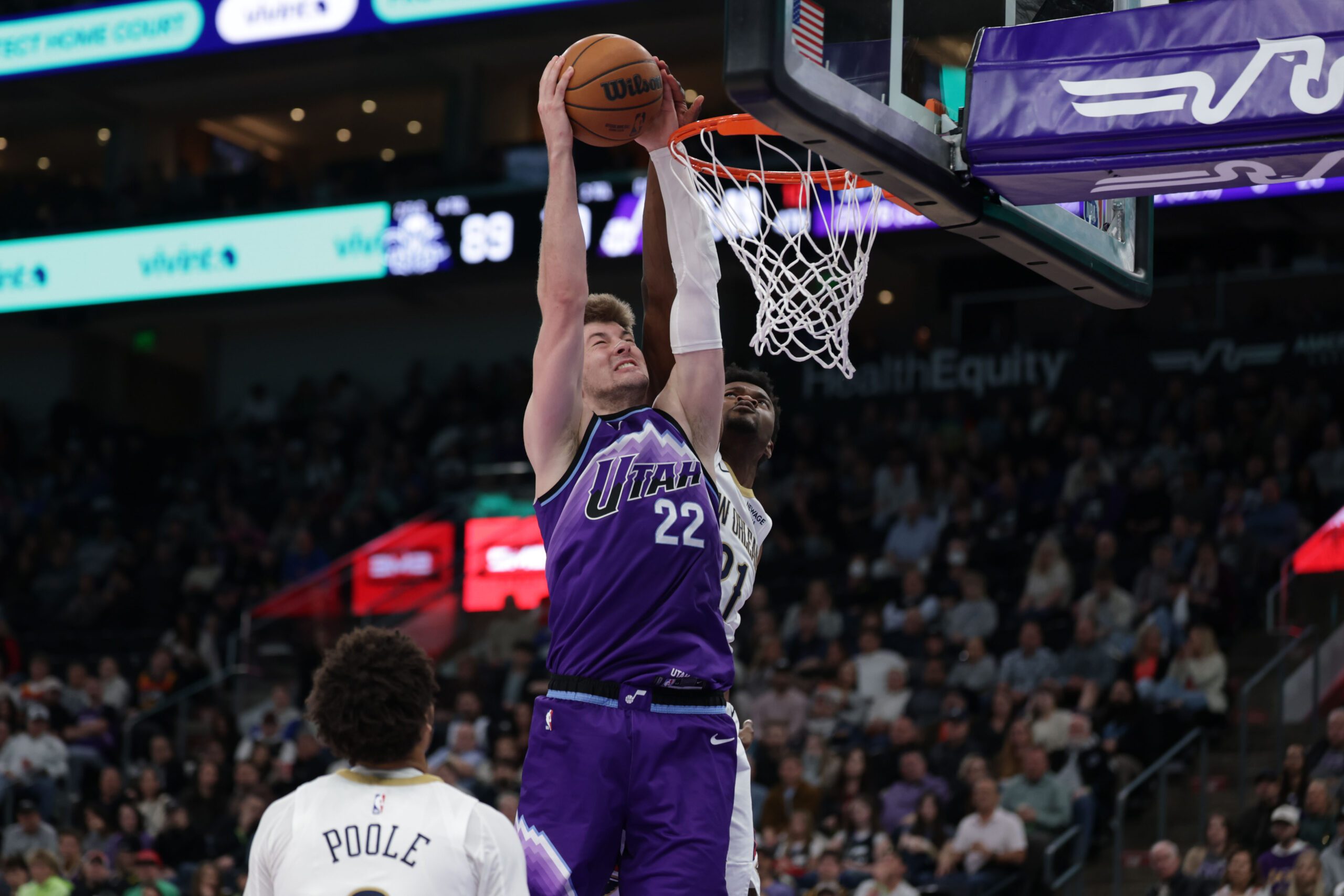 Feb 28, 2026; Salt Lake City, Utah, USA;  Utah Jazz center Kyle Filipowski (22) gets past New Orleans Pelicans center Yves Missi (21) and dunks the ball during the second half at Delta Center. Mandatory Credit: Chris Nicoll-Imagn Images