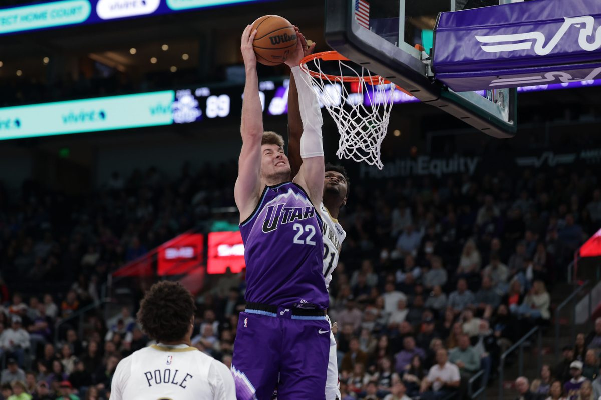 Feb 28, 2026; Salt Lake City, Utah, USA;  Utah Jazz center Kyle Filipowski (22) gets past New Orleans Pelicans center Yves Missi (21) and dunks the ball during the second half at Delta Center. Mandatory Credit: Chris Nicoll-Imagn Images