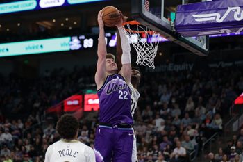 Feb 28, 2026; Salt Lake City, Utah, USA;  Utah Jazz center Kyle Filipowski (22) gets past New Orleans Pelicans center Yves Missi (21) and dunks the ball during the second half at Delta Center. Mandatory Credit: Chris Nicoll-Imagn Images