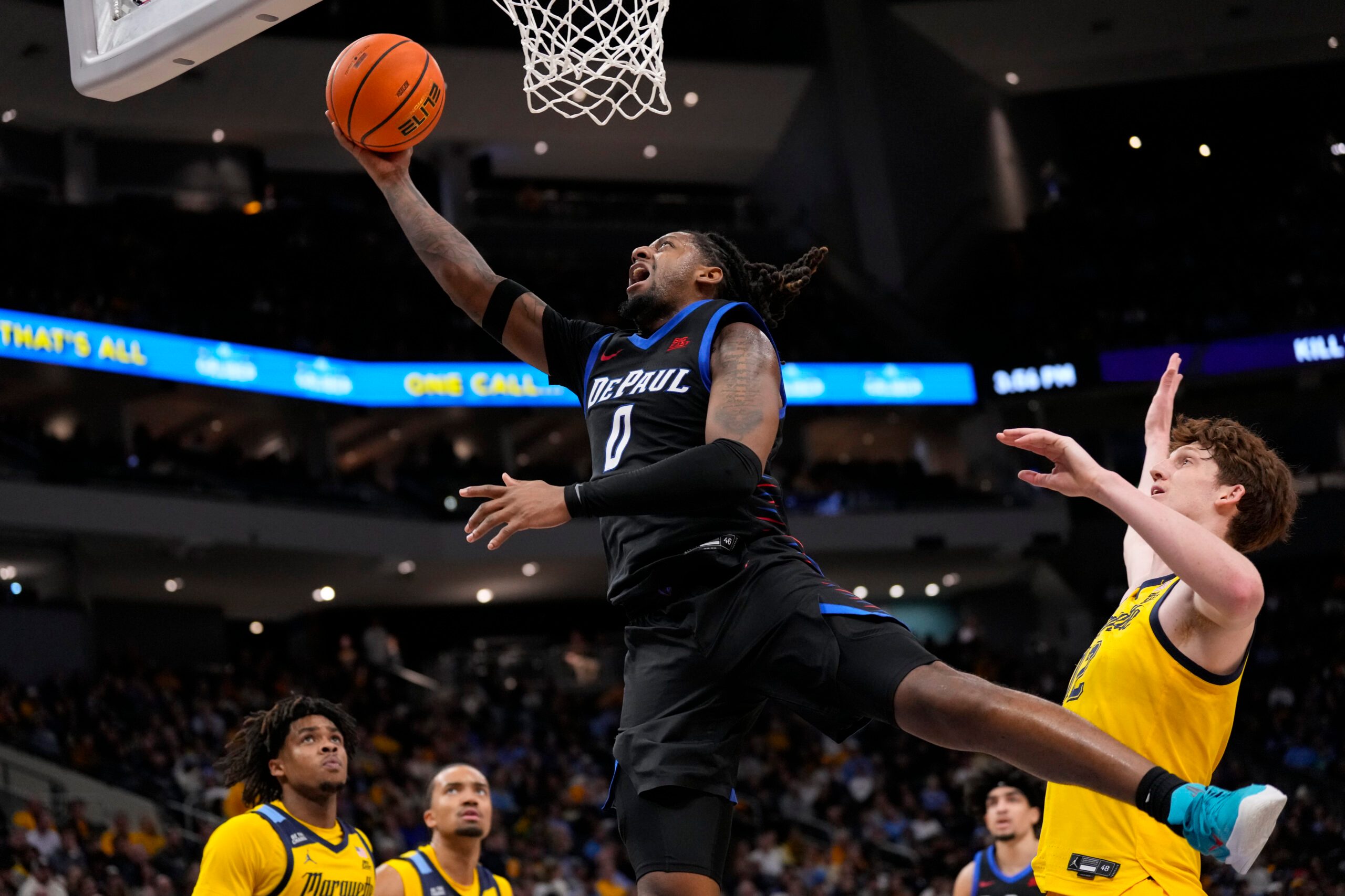 Mar 1, 2026; Milwaukee, Wisconsin, USA;  DePaul Blue Demons guard Brandon Maclin (0) shoots in front of jMarquette Golden Eagles forward Ben Gold (12) during the first half at Fiserv Forum. Mandatory Credit: Jeff Hanisch-Imagn Images