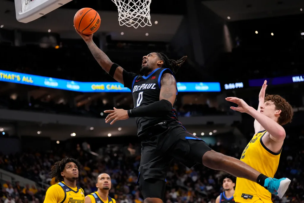 Mar 1, 2026; Milwaukee, Wisconsin, USA; DePaul Blue Demons guard Brandon Maclin (0) shoots in front of jMarquette Golden Eagles forward Ben Gold (12) during the first half at Fiserv Forum. Mandatory Credit: Jeff Hanisch-Imagn Images