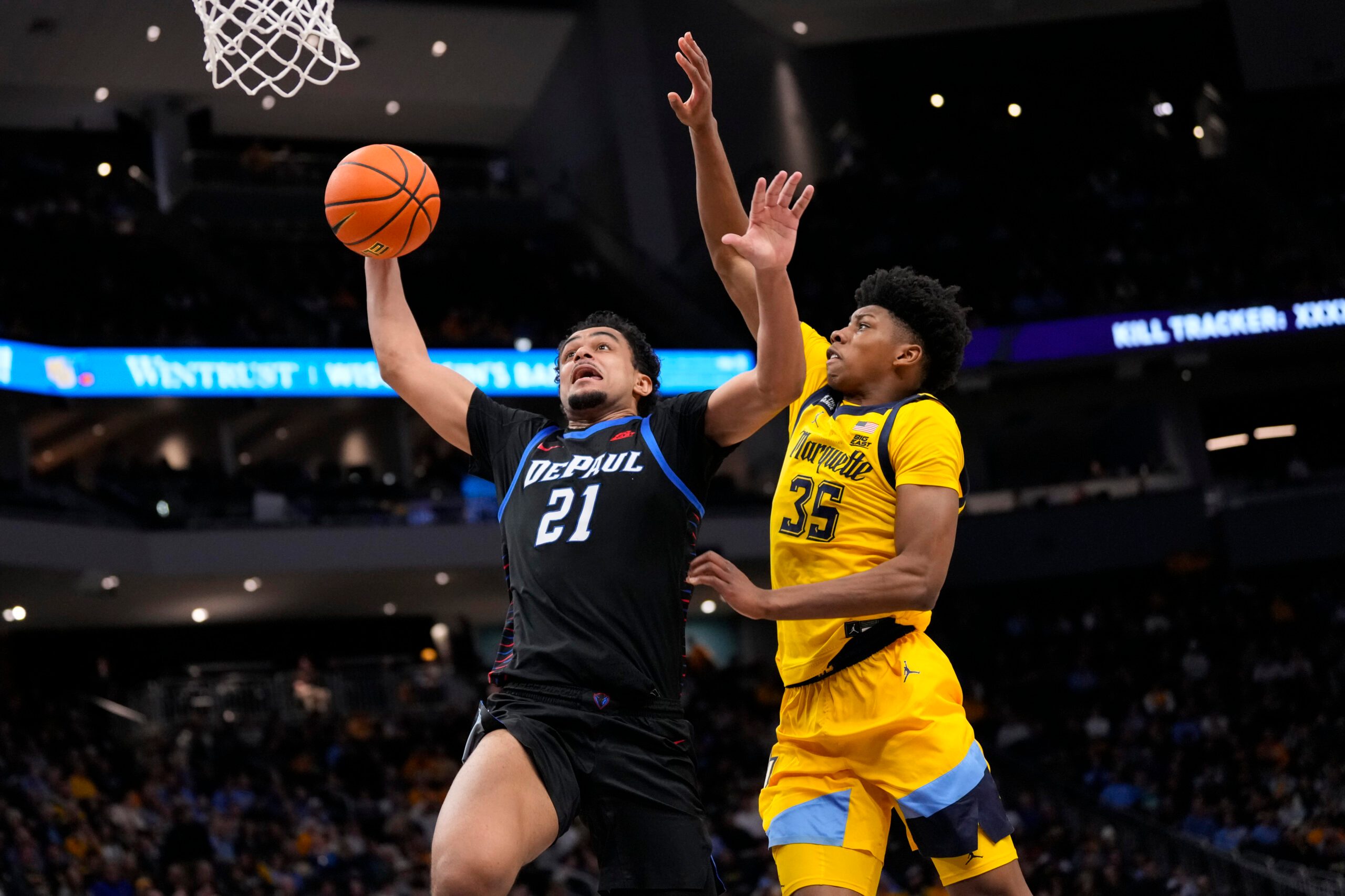 Mar 1, 2026; Milwaukee, Wisconsin, USA;  DePaul Blue Demons forward Theo Pierre-Justin (21) drives for a slam dunk against Marquette Golden Eagles forward Michael Phillips II (35) during the first half at Fiserv Forum. Mandatory Credit: Jeff Hanisch-Imagn Images