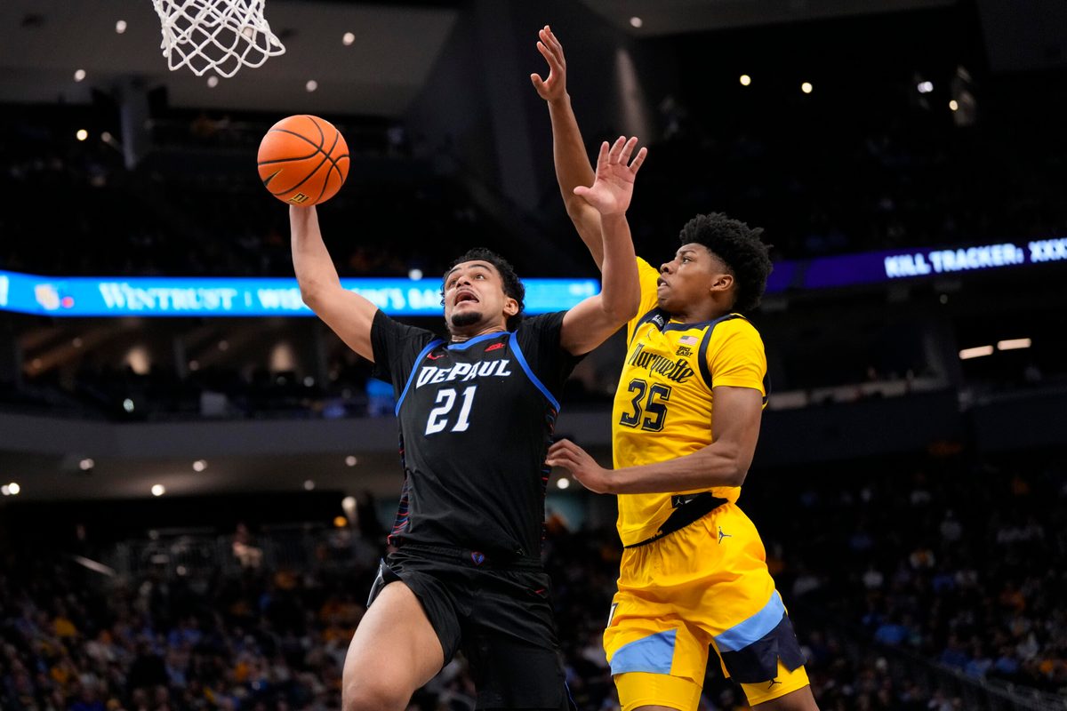 Mar 1, 2026; Milwaukee, Wisconsin, USA; DePaul Blue Demons forward Theo Pierre-Justin (21) drives for a slam dunk against Marquette Golden Eagles forward Michael Phillips II (35) during the first half at Fiserv Forum. Mandatory Credit: Jeff Hanisch-Imagn Images