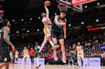 Mar 1, 2026; Atlanta, Georgia, USA; Atlanta Hawks forward Jonathan Kuminga (0) dunks over Portland Trail Blazers center Yang Hansen (16) in the fourth quarter at State Farm Arena. Mandatory Credit: Brett Davis-Imagn Images