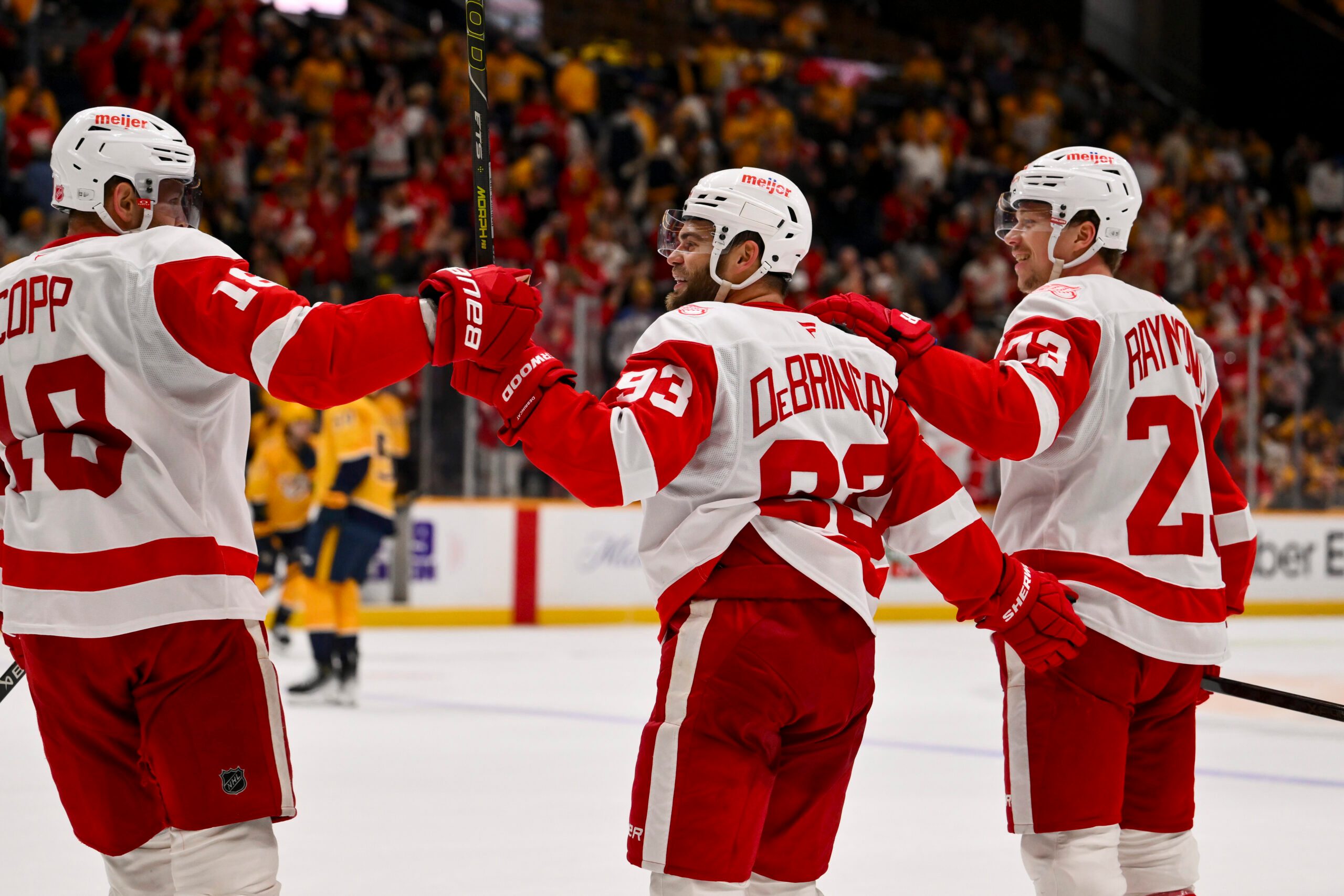 Mar 2, 2026; Nashville, Tennessee, USA;  Detroit Red Wings goaltender Cam Talbot (39) celebrates his goal with center Andrew Copp (18) and left wing Lucas Raymond (23) against the Nashville Predators during the third period at Bridgestone Arena. Mandatory Credit: Steve Roberts-Imagn Images