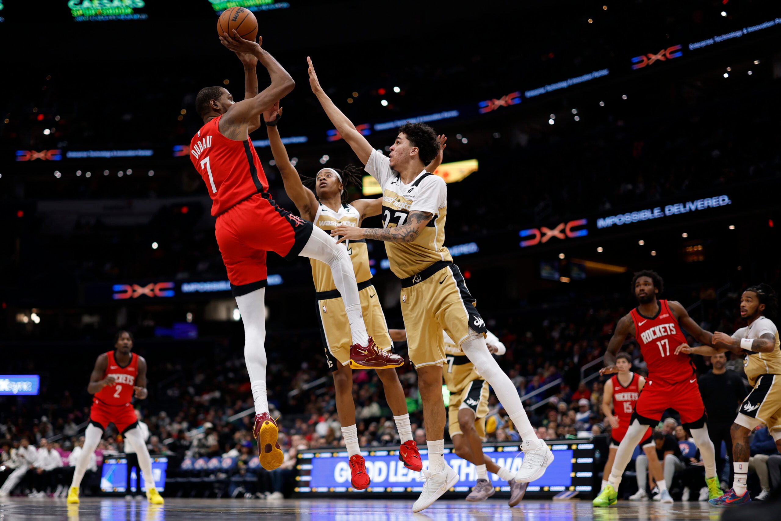 Mar 2, 2026; Washington, District of Columbia, USA; Houston Rockets forward Kevin Durant (7) shoots the ball over Washington Wizards guard Tre Johnson (12) and Wizards guard Will Riley (27) in the second half at Capital One Arena. Mandatory Credit: Geoff Burke-Imagn Images