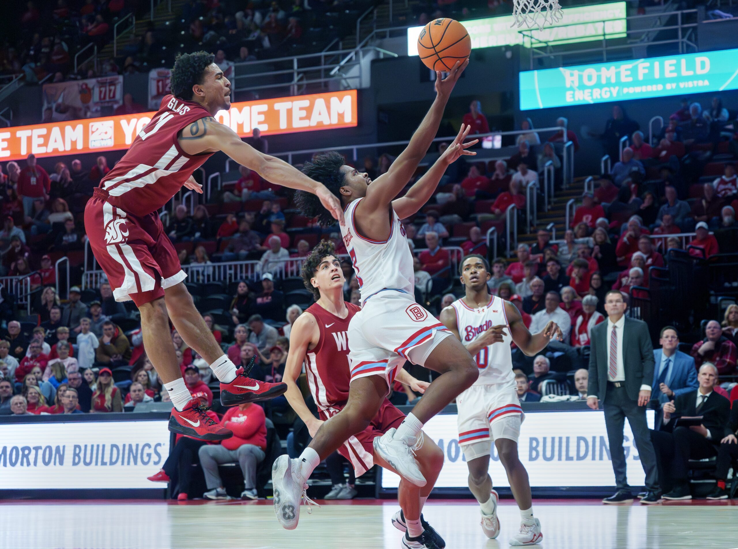 Bradley’s Montana Wheller gets past Washington State’s Ace Glass for a shot in the second half of their college basketball game Tuesday, Dec. 2, 2025 at Carver Arena in Peoria. The Braves rallied for a 64-60 victory.