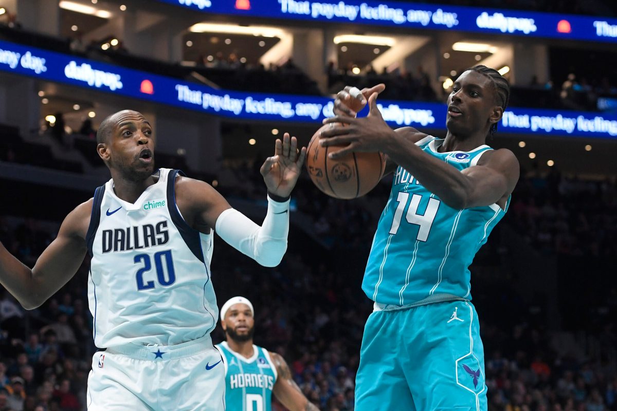 Mar 3, 2026; Charlotte, North Carolina, USA; Dallas Mavericks forward Khris Middleton (20) and Charlotte Hornets forward center Moussa Diabate (14) fight for a rebound during the first half at the Spectrum Center. Mandatory Credit: Sam Sharpe-Imagn Images