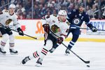 Mar 3, 2026; Winnipeg, Manitoba, CAN;  Chicago Blackhawks forward Andre Burakovsky (28) skates into the Winnipeg Jets zone during the first period at Canada Life Centre. Mandatory Credit: Terrence Lee-Imagn Images