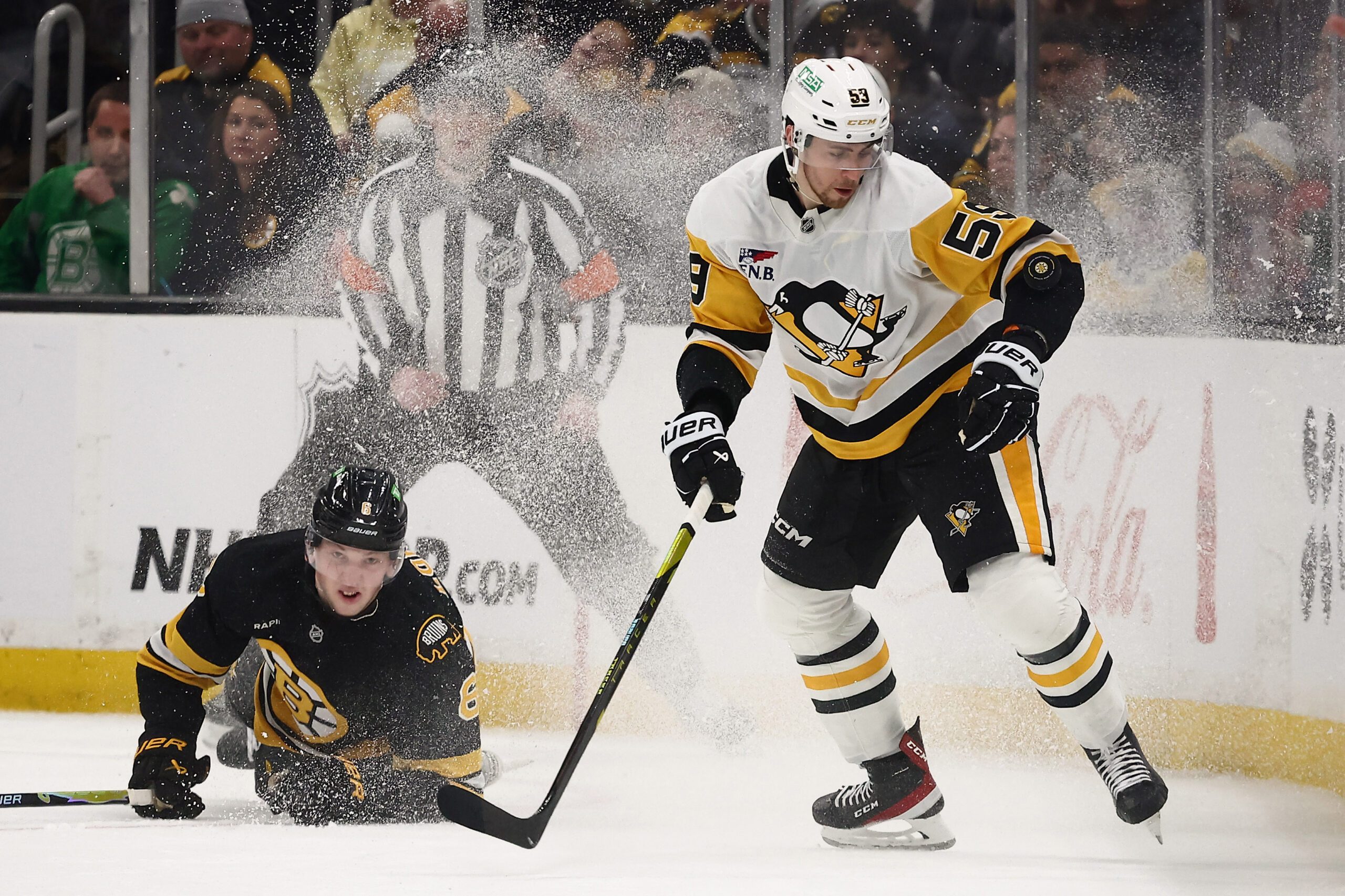 Mar 3, 2026; Boston, Massachusetts, USA; Pittsburgh Penguins right wing Egor Chinakhov (59) eyes a loose puck  as Boston Bruins defenseman Mason Lohrei (6) tumbles behind him during the third period at TD Garden. Mandatory Credit: Winslow Townson-Imagn Images