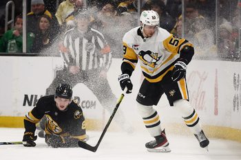 Mar 3, 2026; Boston, Massachusetts, USA; Pittsburgh Penguins right wing Egor Chinakhov (59) eyes a loose puck  as Boston Bruins defenseman Mason Lohrei (6) tumbles behind him during the third period at TD Garden. Mandatory Credit: Winslow Townson-Imagn Images