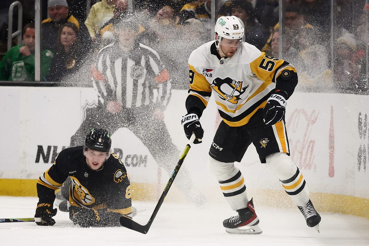 Mar 3, 2026; Boston, Massachusetts, USA; Pittsburgh Penguins right wing Egor Chinakhov (59) eyes a loose puck as Boston Bruins defenseman Mason Lohrei (6) tumbles behind him during the third period at TD Garden. Mandatory Credit: Winslow Townson-Imagn Images