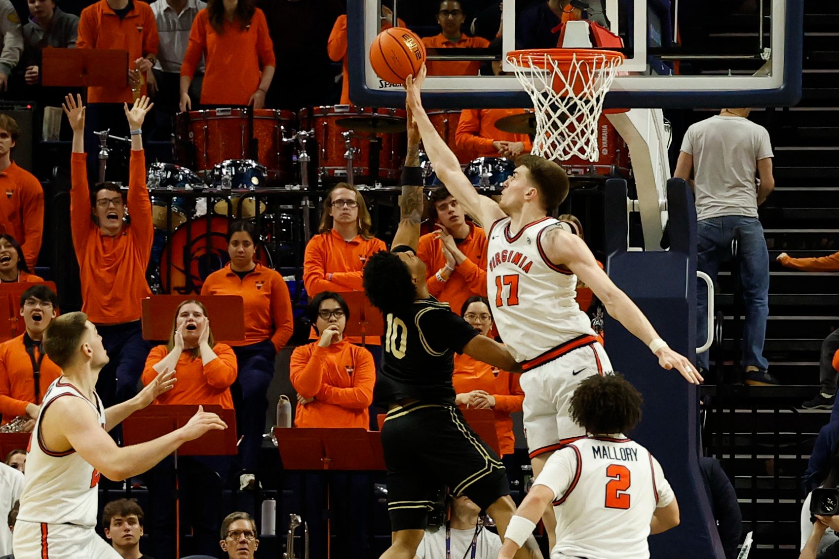 Mar 3, 2026; Charlottesville, Virginia, USA; Virginia Cavaliers center Johann Grünloh (17) blocks the shot of Wake Forest Demon Deacons guard Sebastian Akins (10) in the second half at John Paul Jones Arena. Mandatory Credit: Geoff Burke-Imagn Images
