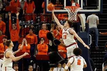Mar 3, 2026; Charlottesville, Virginia, USA; Virginia Cavaliers center Johann Grünloh (17) blocks the shot of Wake Forest Demon Deacons guard Sebastian Akins (10) in the second half at John Paul Jones Arena. Mandatory Credit: Geoff Burke-Imagn Images