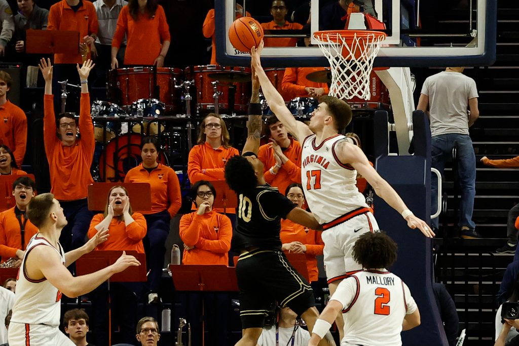 Mar 3, 2026; Charlottesville, Virginia, USA; Virginia Cavaliers center Johann Grünloh (17) blocks the shot of Wake Forest Demon Deacons guard Sebastian Akins (10) in the second half at John Paul Jones Arena. Mandatory Credit: Geoff Burke-Imagn Images