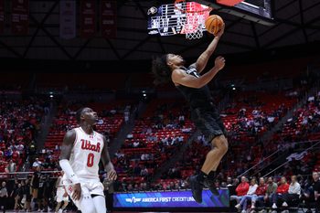 Mar 3, 2026; Salt Lake City, Utah, USA; Colorado Buffaloes guard Josiah Sanders (5) goes for a lay up against Utah Utes forward Seydou Traore (0) during the first half at Jon M. Huntsman Center. Mandatory Credit: Rob Gray-Imagn Images