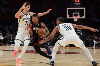 Mar 3, 2026; Miami, Florida, USA; Miami Heat guard Jahmir Young (17) drives to the basket against Brooklyn Nets guard Ben Saraf (77) and guard Ochai Agbaji (30) during the fourth quarter at Kaseya Center. Mandatory Credit: Sam Navarro-Imagn Images