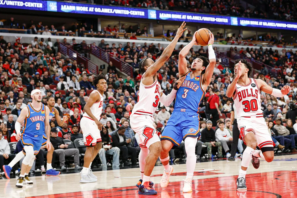 Mar 3, 2026; Chicago, Illinois, USA; Oklahoma City Thunder guard Jared McCain (3) shoots against Chicago Bulls forward Isaac Okoro (35) during the second half at United Center. Mandatory Credit: Kamil Krzaczynski-Imagn Images