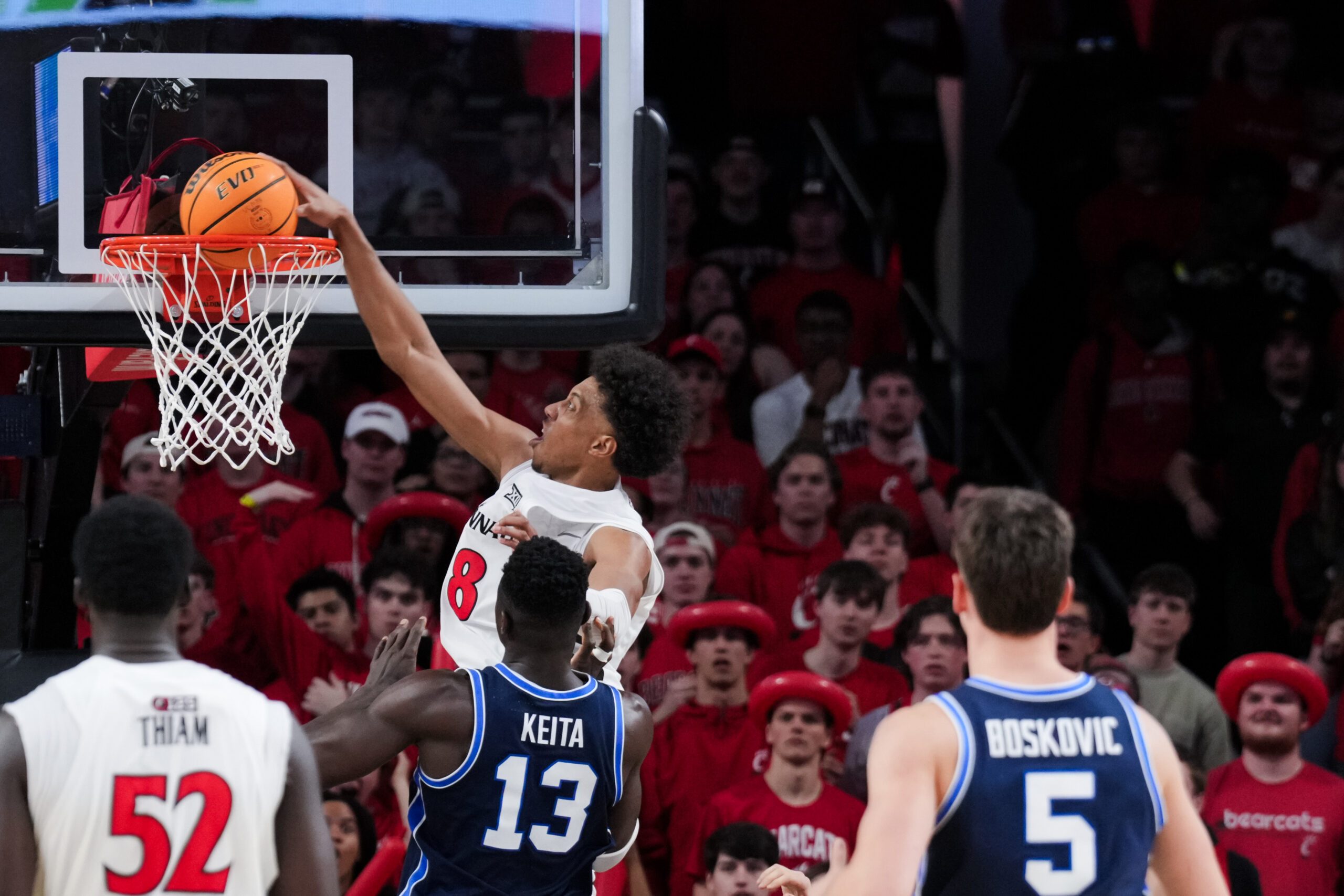 Mar 3, 2026; Cincinnati, Ohio, USA;  Cincinnati Bearcats forward Baba Miller (18) dunks the ball against BYU Cougars center Keba Keita (13) in the second half at Fifth Third Arena. Mandatory Credit: Aaron Doster-Imagn Images