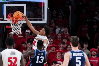 Mar 3, 2026; Cincinnati, Ohio, USA;  Cincinnati Bearcats forward Baba Miller (18) dunks the ball against BYU Cougars center Keba Keita (13) in the second half at Fifth Third Arena. Mandatory Credit: Aaron Doster-Imagn Images